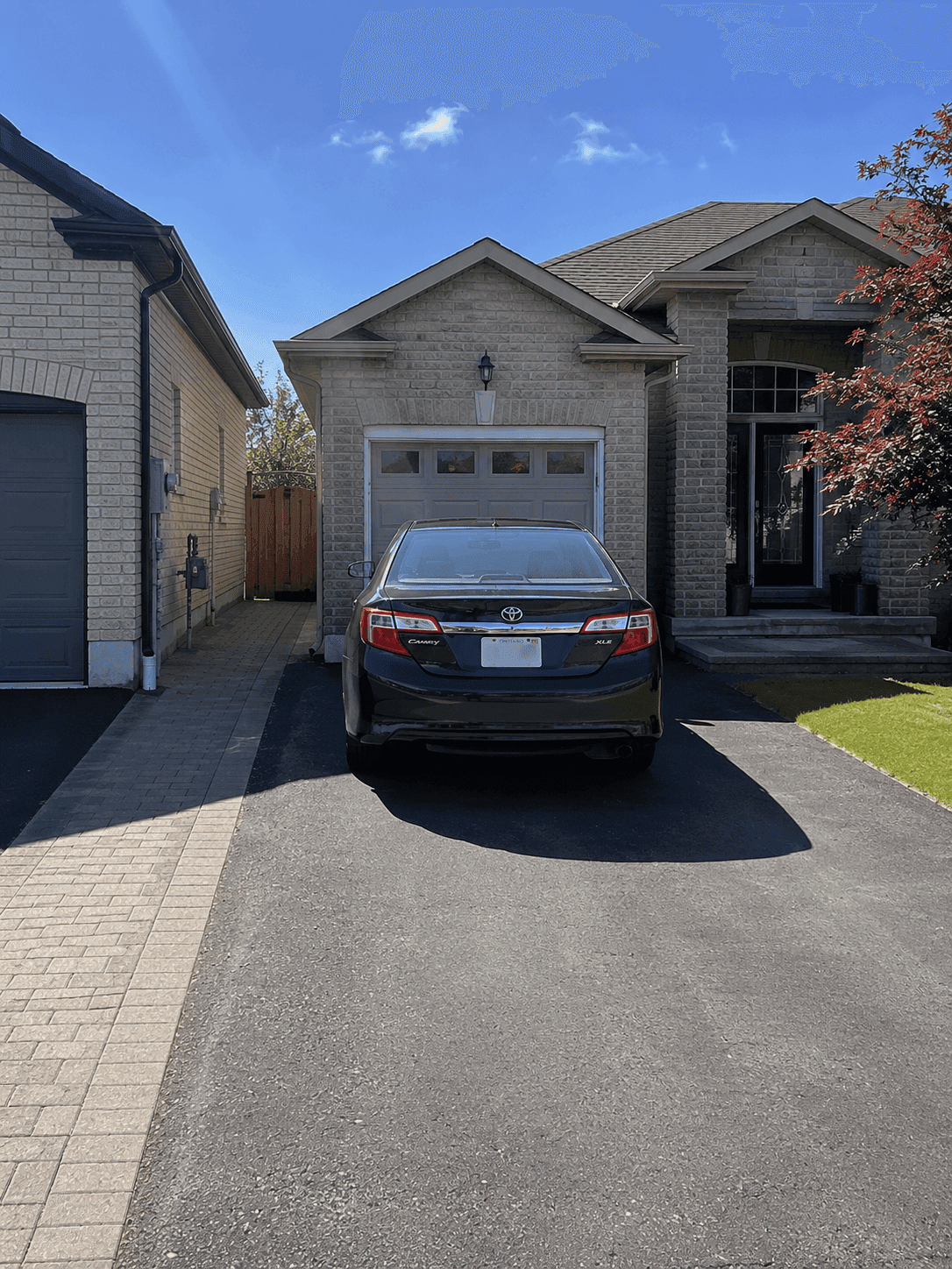 The driveway from the street with the front space empty
