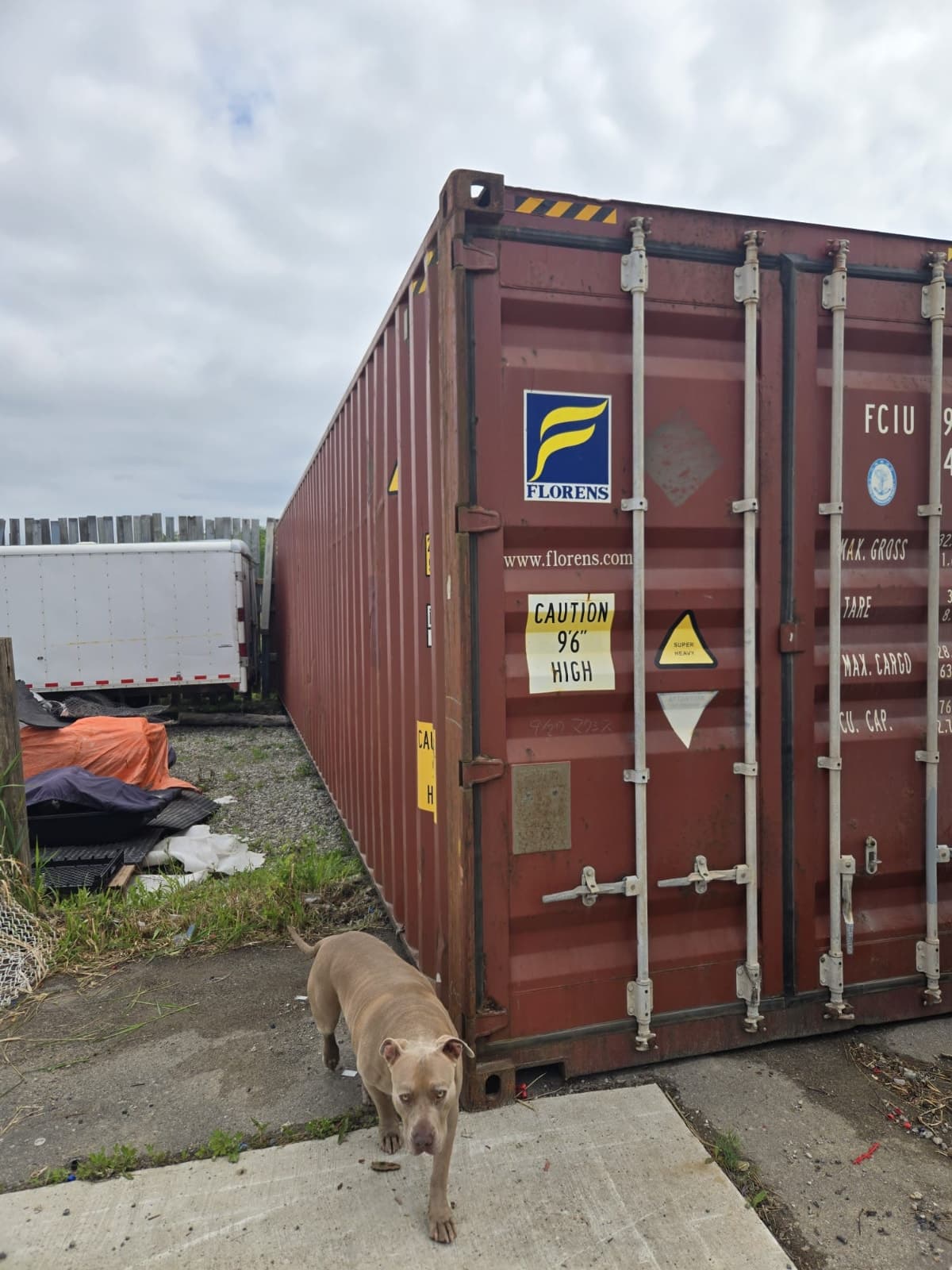 Large gated outdoor storage yard with 40ft container