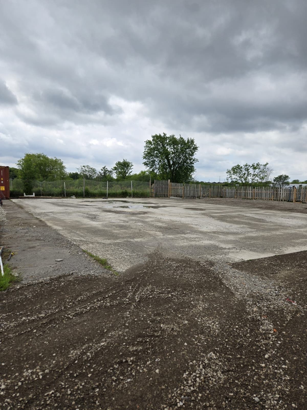 Large gated outdoor storage yard with 40ft container