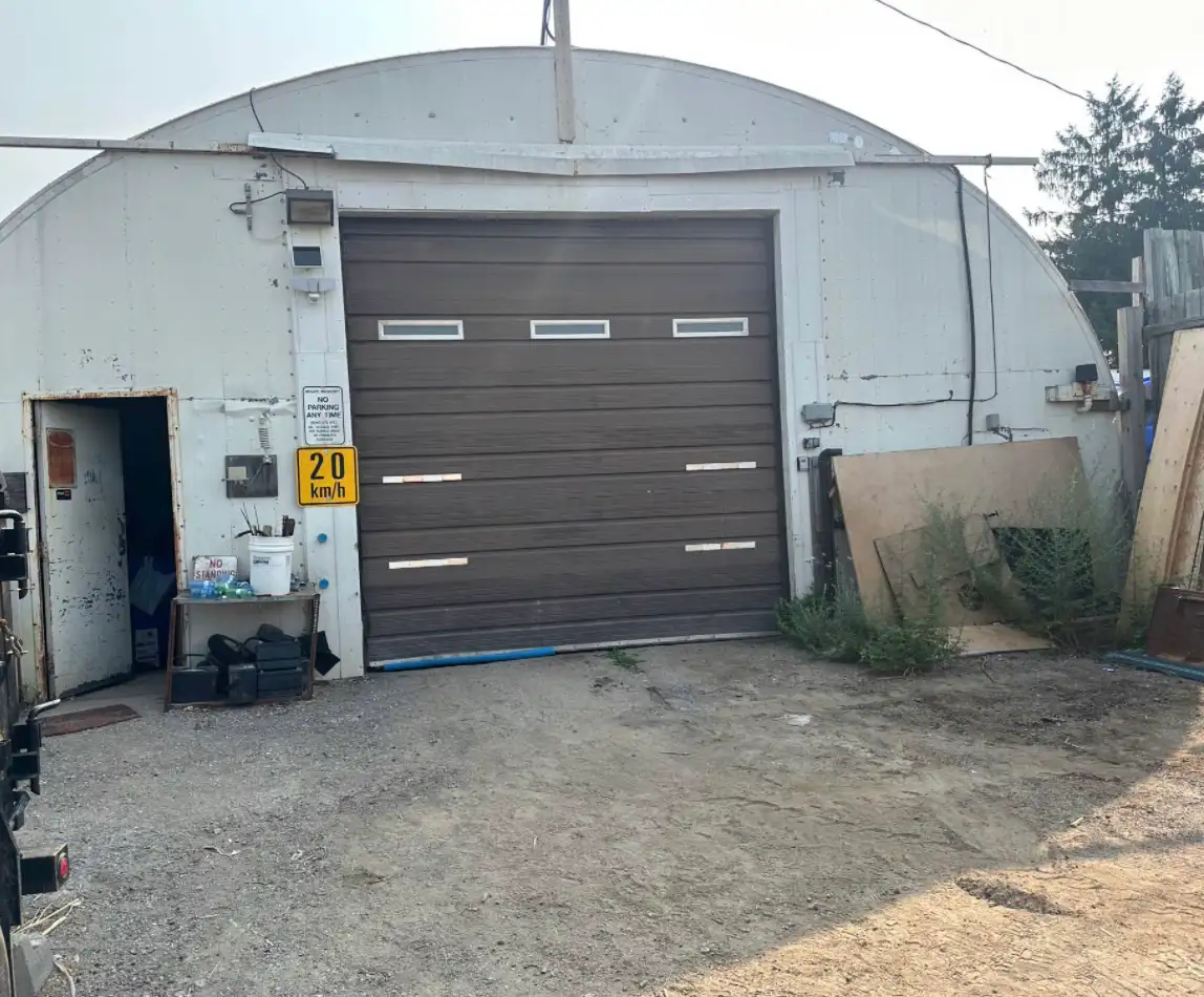 The unit from the yard, roll-up door and drive-up apron